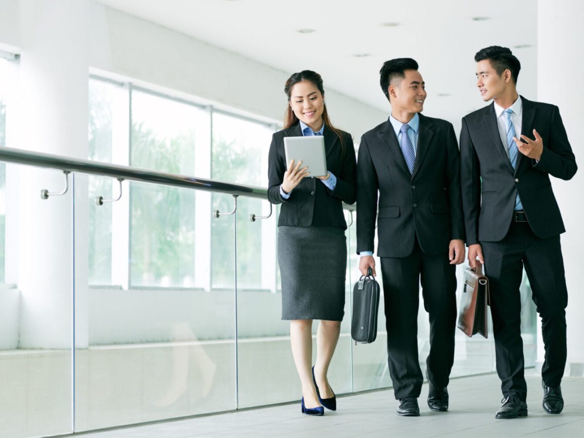 Young business colleagues talking on the way to work